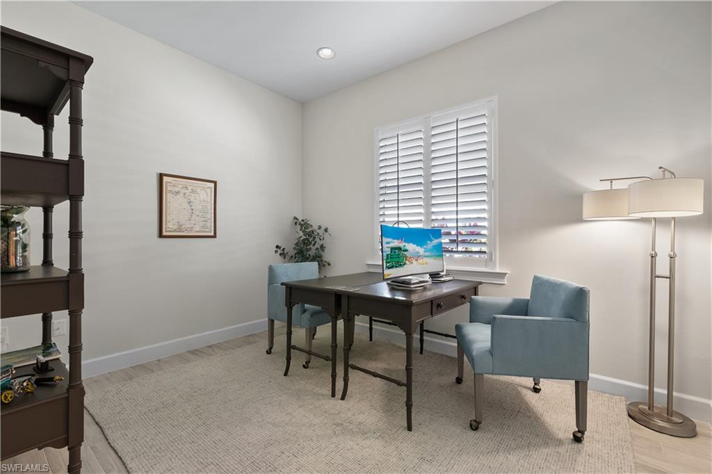 6359 Antigua Way Naples, FL 34113 - Photo 24 of 48 a view of a workspace with furniture and a window