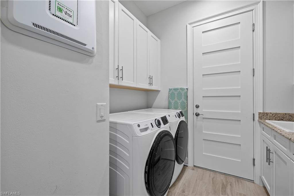 6359 Antigua Way Naples, FL 34113 - Photo 25 of 48 a utility room with dryer and washer
