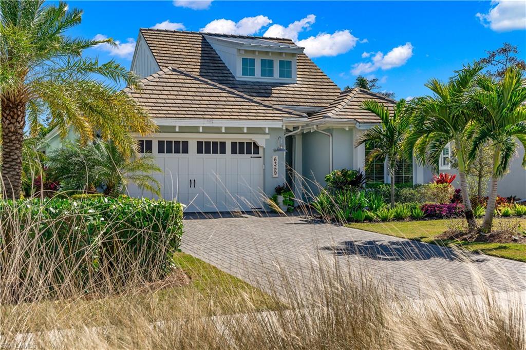 6359 Antigua Way Naples, FL 34113 - Photo 26 of 48 a front view of a house with a yard