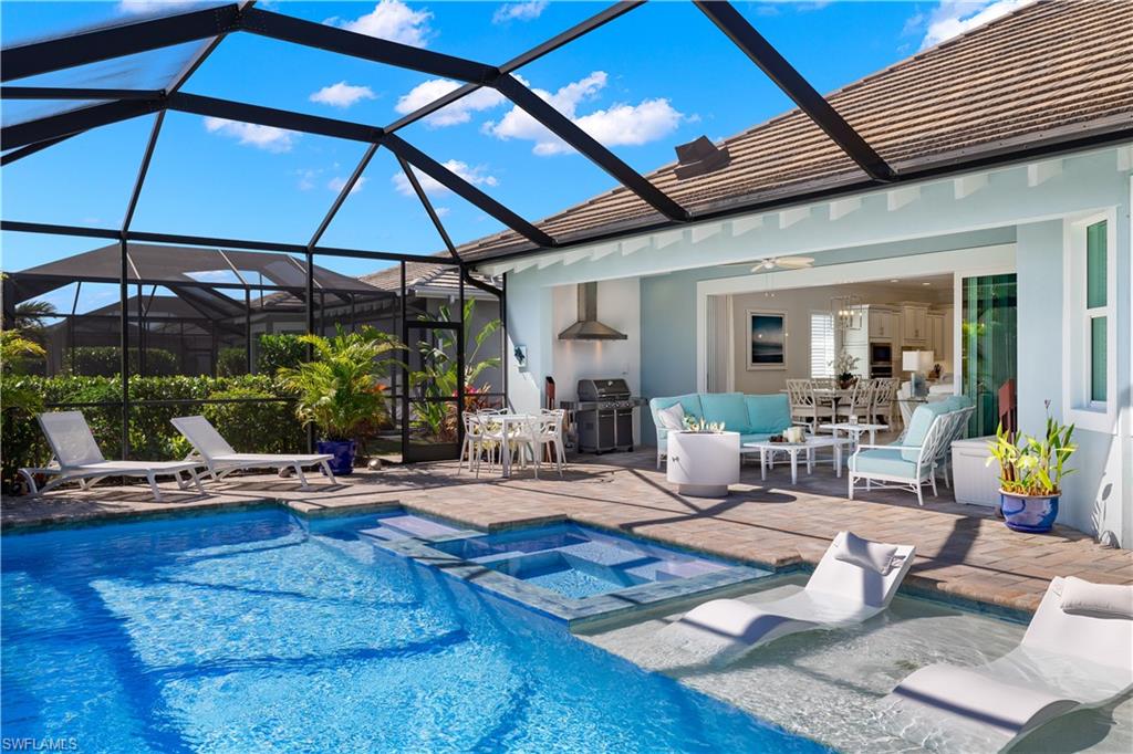 6359 Antigua Way Naples, FL 34113 - Photo 31 of 48 a living room with lots of furniture and white umbrella