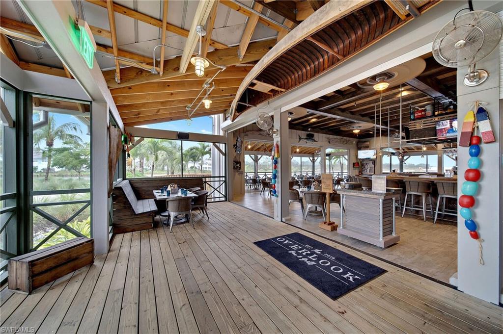 6359 Antigua Way Naples, FL 34113 - Photo 45 of 48 a view of outdoor sitting area with wooden floor