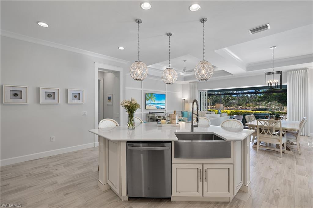 6359 Antigua Way Naples, FL 34113 - Photo 6 of 48 a room with stainless steel appliances kitchen island a large island in the center