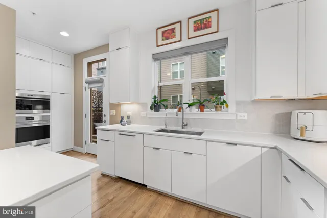 a kitchen with cabinets and window