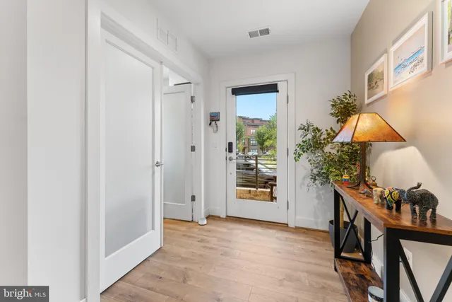 a view of an entryway with wooden floor