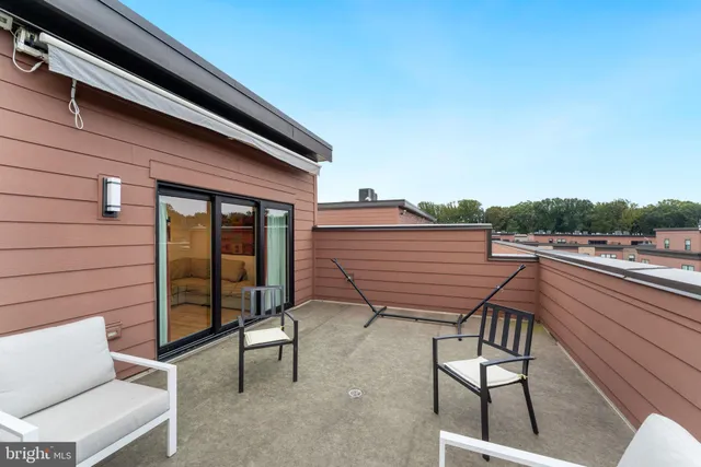 a view of a chairs setting on the roof deck