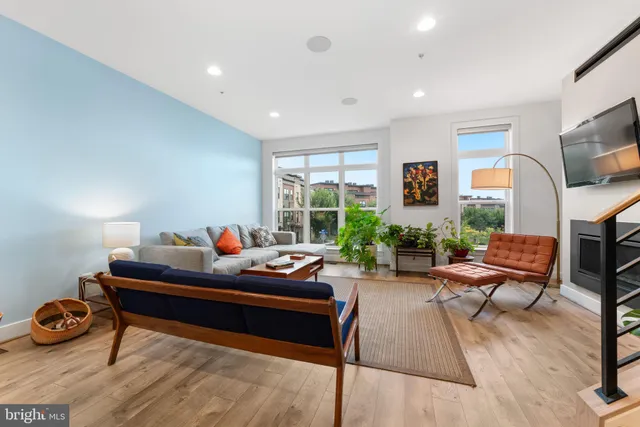 a living room with furniture fireplace and a flat screen tv