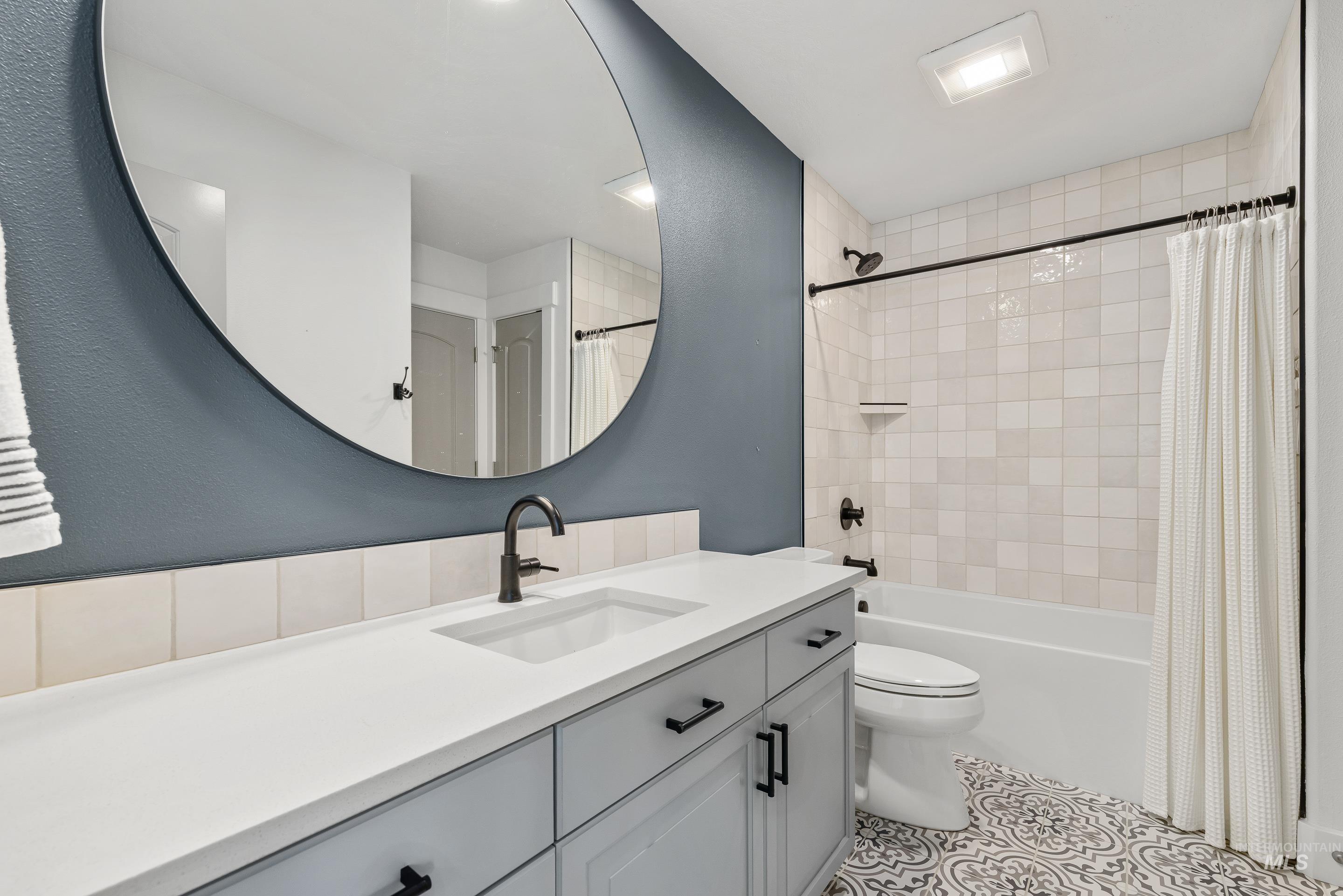 1166 East Rivers End Drive Eagle, ID 83616 - Photo 40 of 50 Full bathroom featuring vanity, shower / tub combo with curtain, and light tile patterned flooring