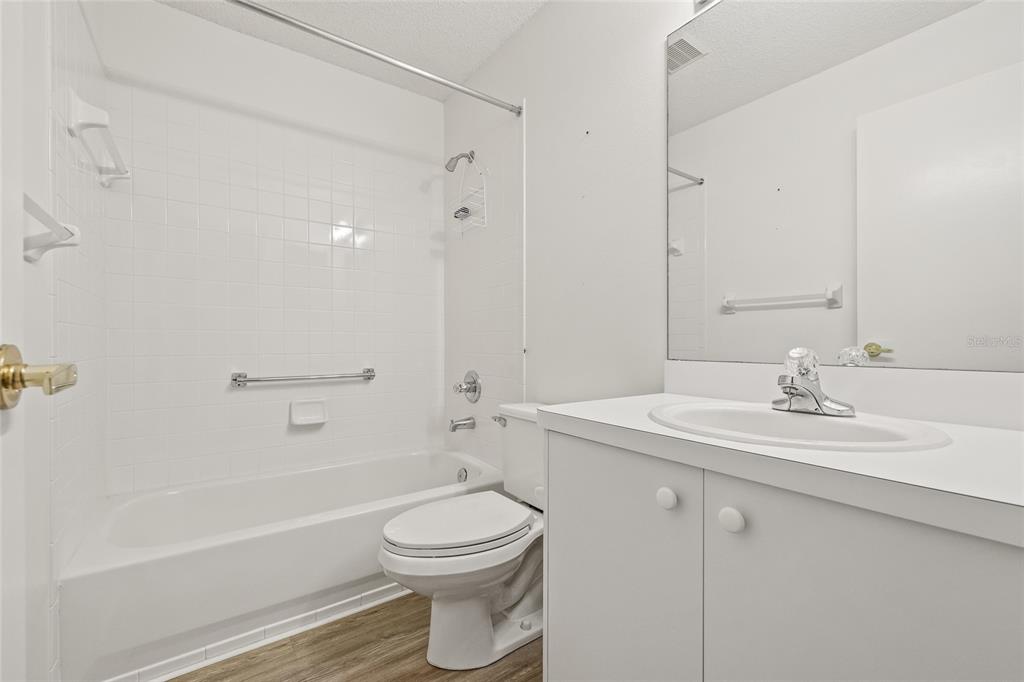 7343 Willowbrook Drive Spring Hill, FL 34606 - Photo 12 of 47 a bathroom with a toilet a sink a mirror a bathtub and vanity