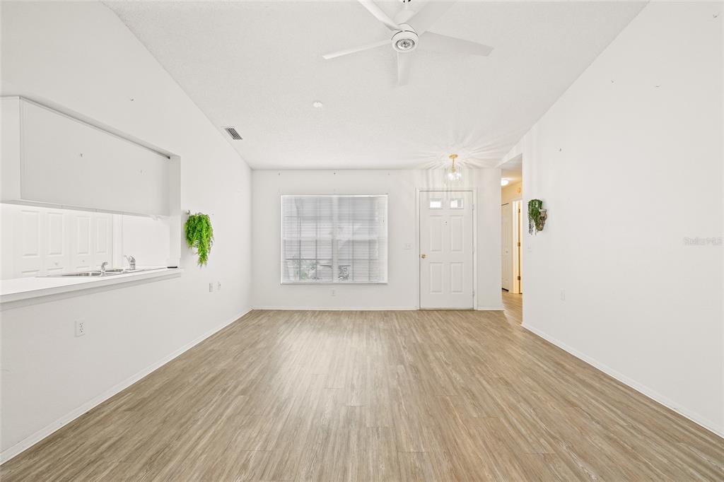 7343 Willowbrook Drive Spring Hill, FL 34606 - Photo 15 of 47 wooden floor in an empty room with a window