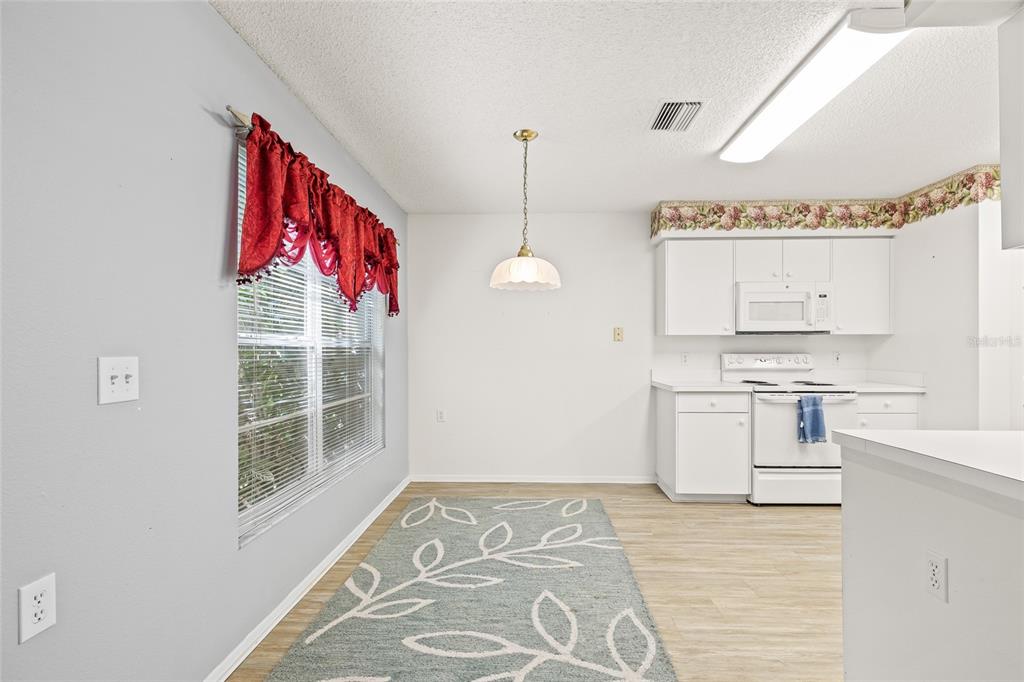 7343 Willowbrook Drive Spring Hill, FL 34606 - Photo 16 of 47 a view of a kitchen with a stove cabinets