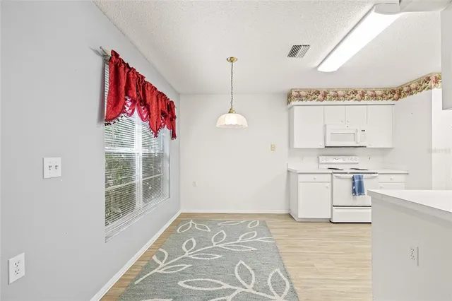 a view of a kitchen with a stove cabinets
