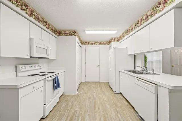 a kitchen with a stove a sink and a refrigerator