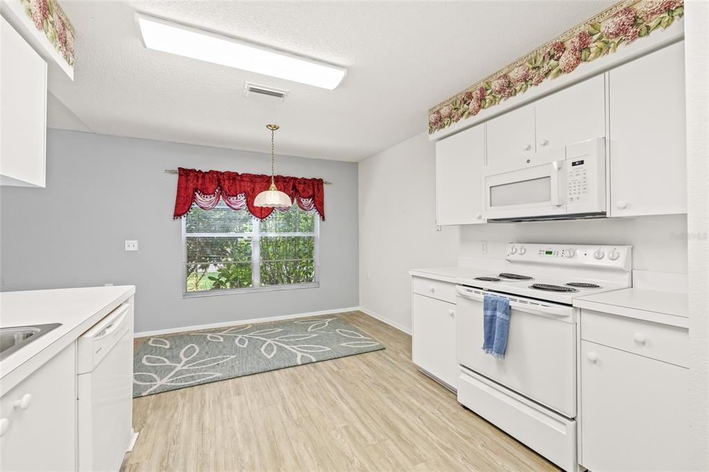 7343 Willowbrook Drive Spring Hill, FL 34606 - Photo 20 of 47 a kitchen with a stove a sink and a refrigerator