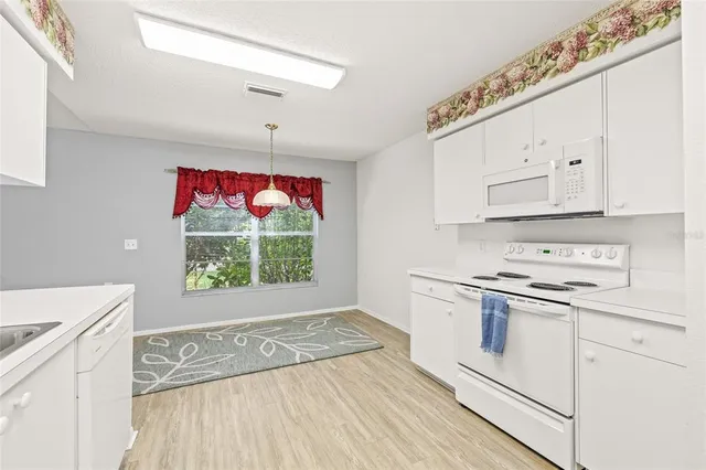 a kitchen with a stove a sink and a refrigerator