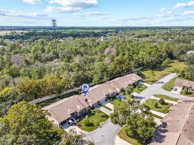 an aerial view of a houses with a yard