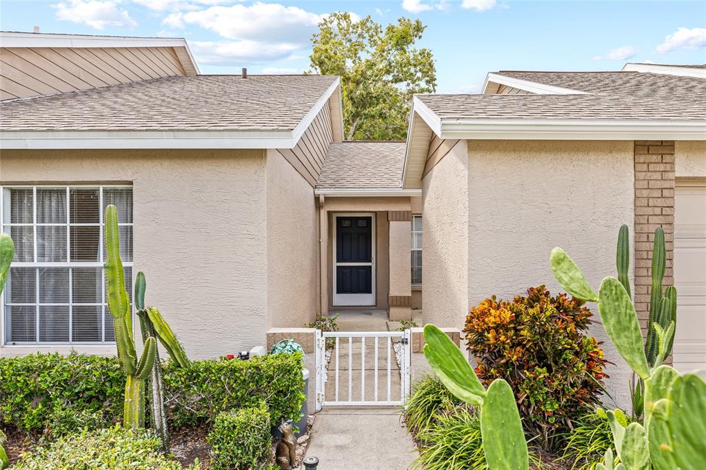 7343 Willowbrook Drive Spring Hill, FL 34606 - Photo 3 of 47 a front view of a house with garden