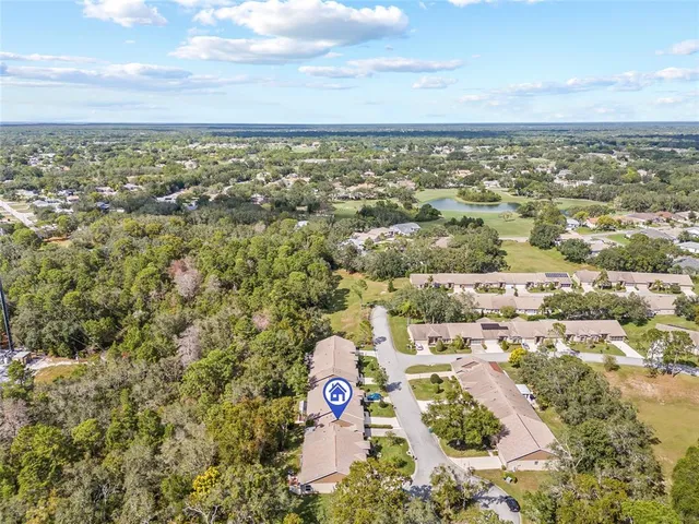 an aerial view of residential building and lake