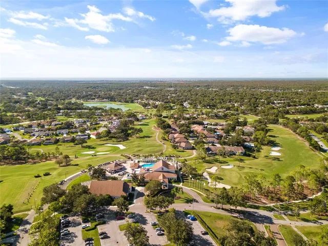 a view of a street with a bench and trees around