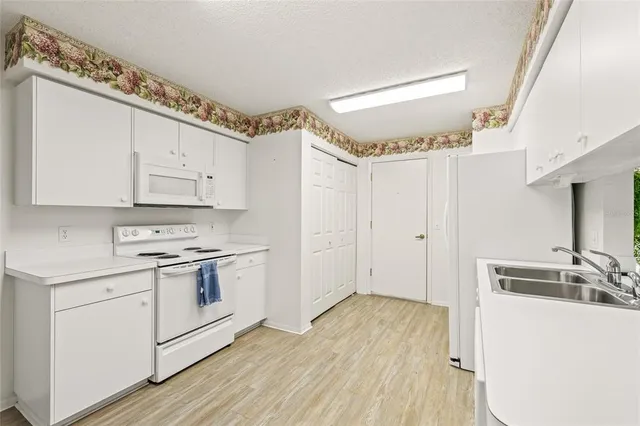 a kitchen with a sink stove and cabinets