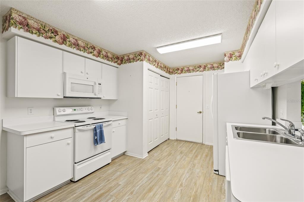 7343 Willowbrook Drive Spring Hill, FL 34606 - Photo 5 of 47 a kitchen with a sink stove and cabinets