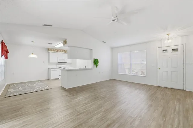 a view of kitchen with wooden floor and electronic appliances