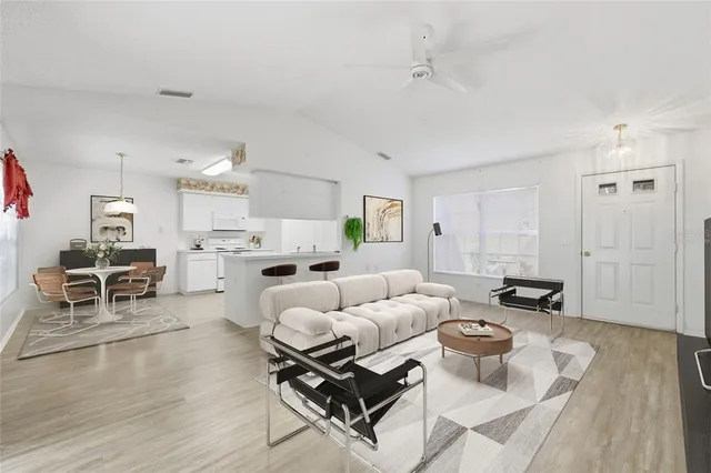 a living room with furniture and kitchen view