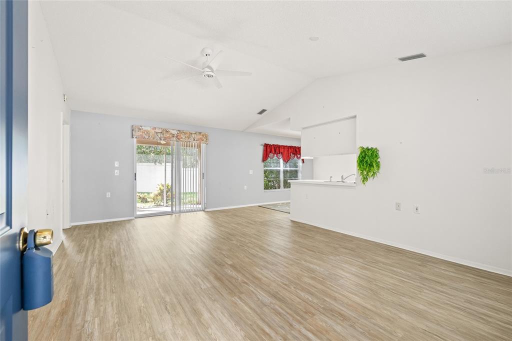 7343 Willowbrook Drive Spring Hill, FL 34606 - Photo 8 of 47 an empty room with wooden floor and windows