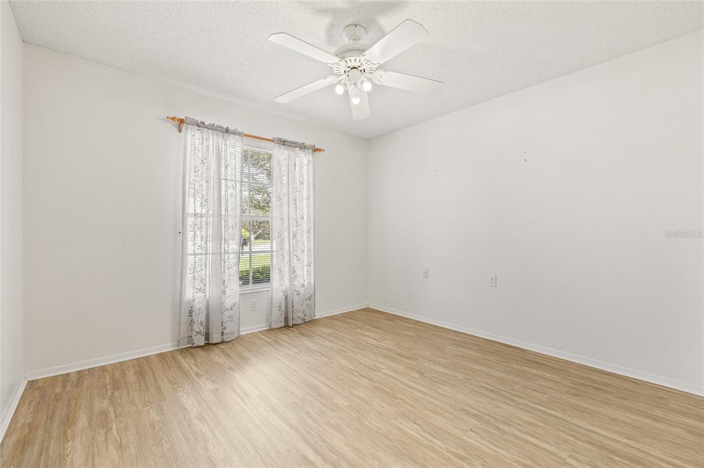 7343 Willowbrook Drive Spring Hill, FL 34606 - Photo 9 of 47 wooden floor in an empty room with a window