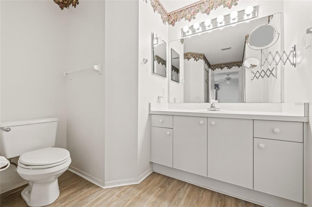 7343 Willowbrook Drive Spring Hill, FL 34606 - Photo 10 of 47 a bathroom with a toilet sink and mirror