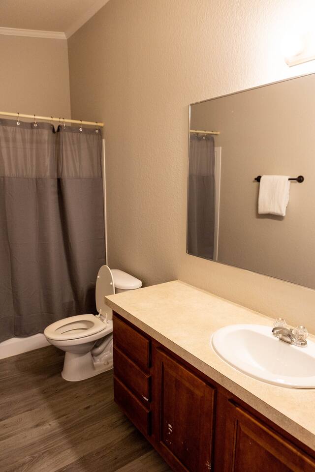 1901 Harmon Hills Road Dripping Springs, TX 78620 - Photo 23 of 27 Full bathroom with vanity, dark wood-style flooring, and shower / tub combo with curtain