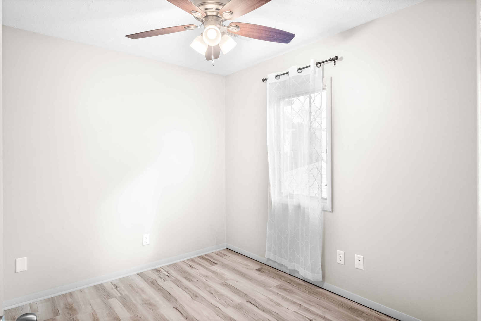 903 North Linden Street, Unit 17 Normal, IL 61761 - Photo 13 of 26 an empty room with a window and a fan