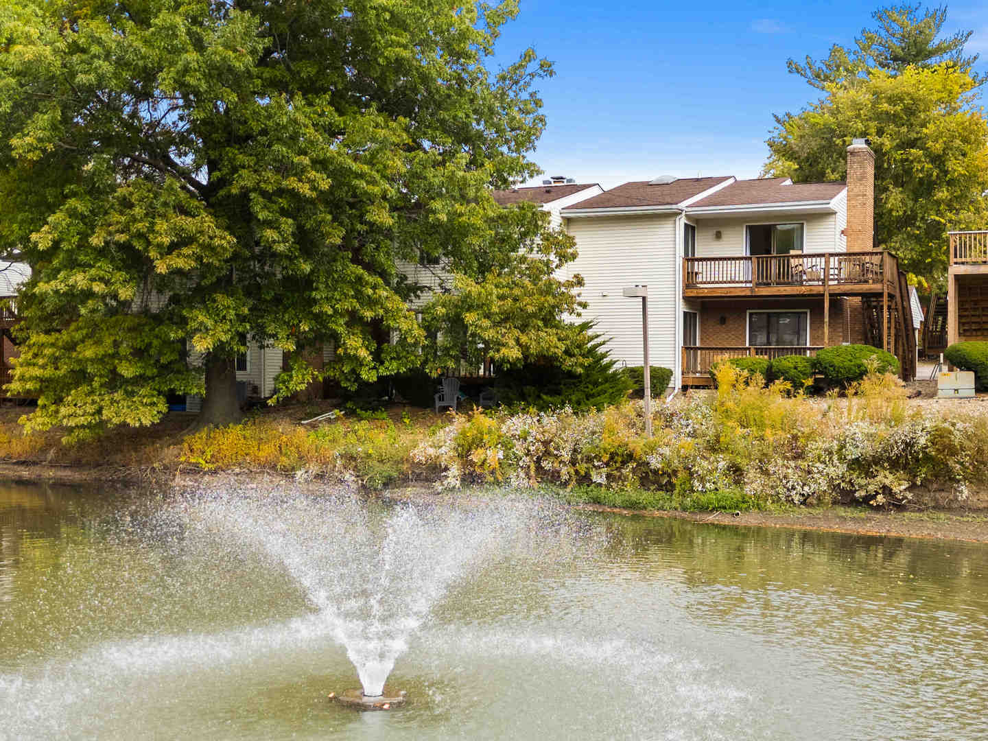 903 North Linden Street, Unit 17 Normal, IL 61761 - Photo 26 of 26 a view of a lake with a house in the background