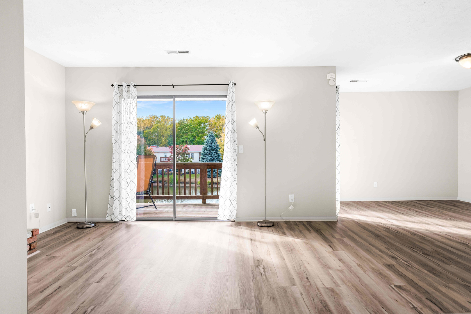 903 North Linden Street, Unit 17 Normal, IL 61761 - Photo 5 of 26 an empty room with wooden floor and windows