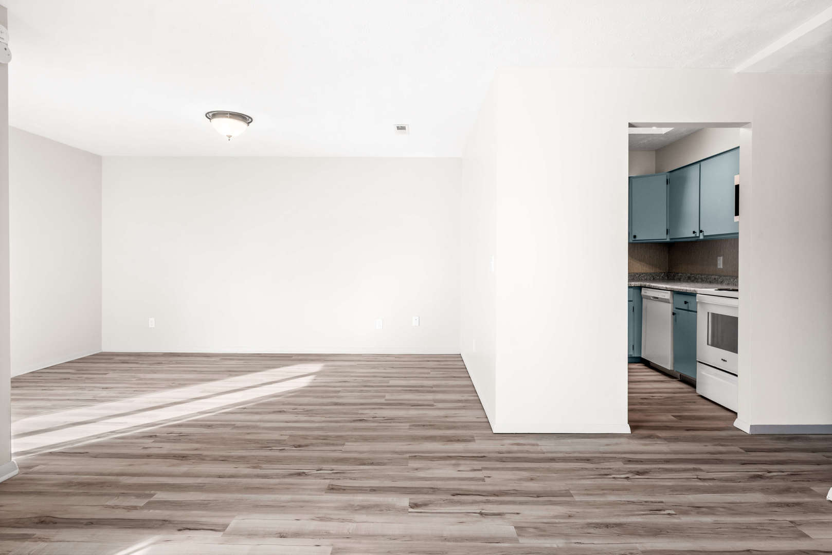 903 North Linden Street, Unit 17 Normal, IL 61761 - Photo 6 of 26 a view of kitchen and empty room with wooden floor