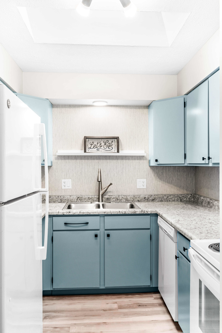 903 North Linden Street, Unit 17 Normal, IL 61761 - Photo 10 of 26 a kitchen with a sink a refrigerator and cabinets