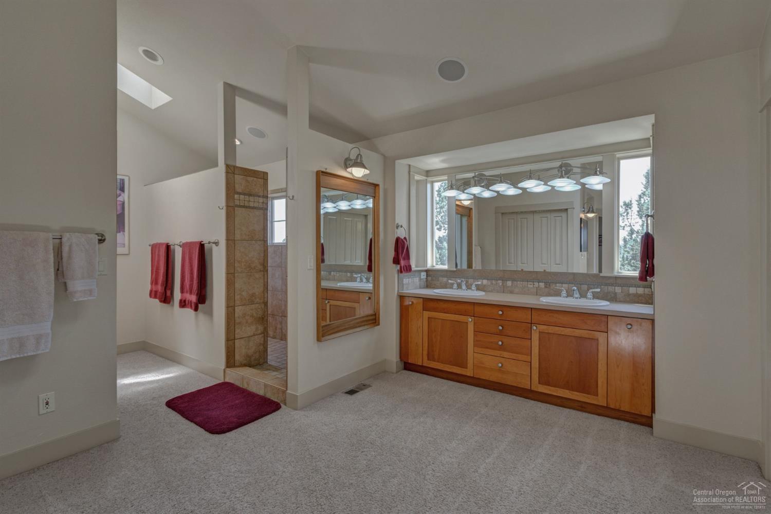 64405 Deschutes Market Road Bend, OR 97701 - Photo 12 of 25 a spacious bathroom with a tub sink and mirror