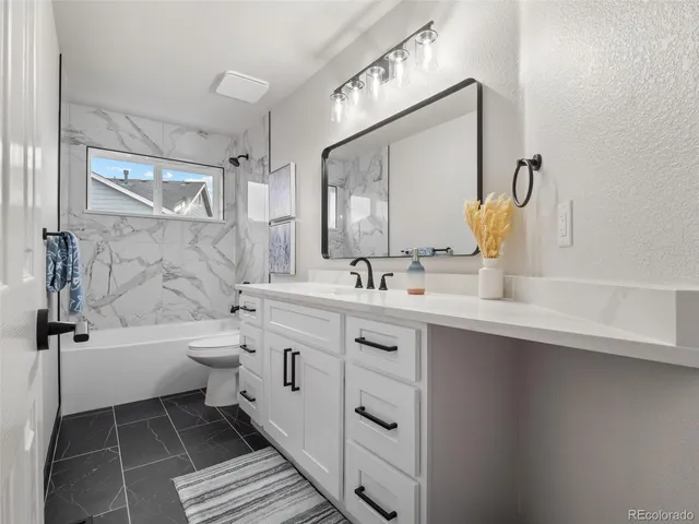a kitchen with appliances a sink and cabinets
