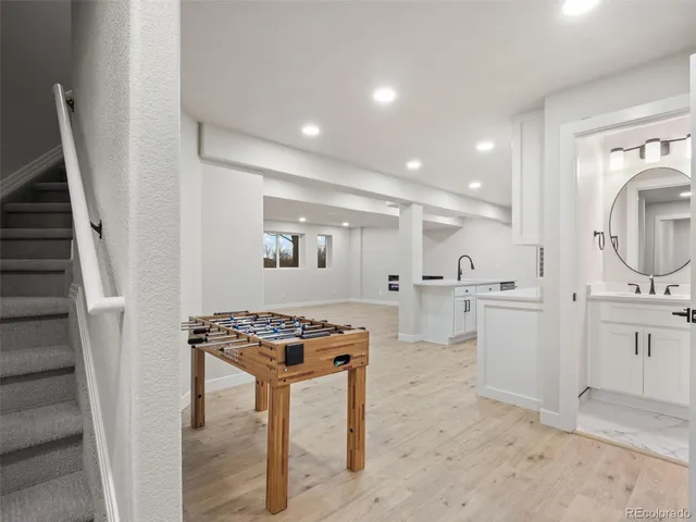 an empty room with wooden floor and a hallway