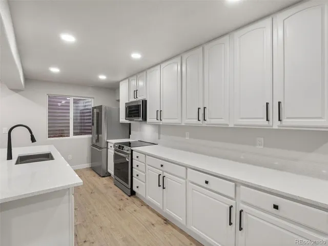 a bathroom with a double vanity sink mirror and toilet