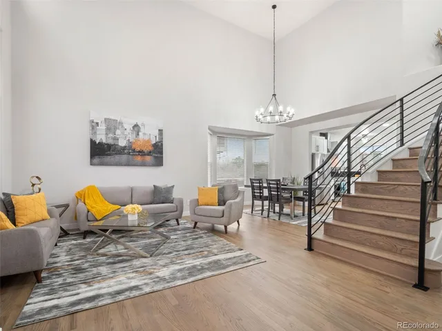 a living room with furniture a rug and white walls