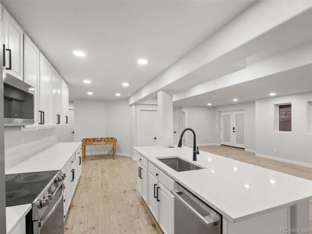 a bathroom with a granite countertop sink mirror vanity and toilet