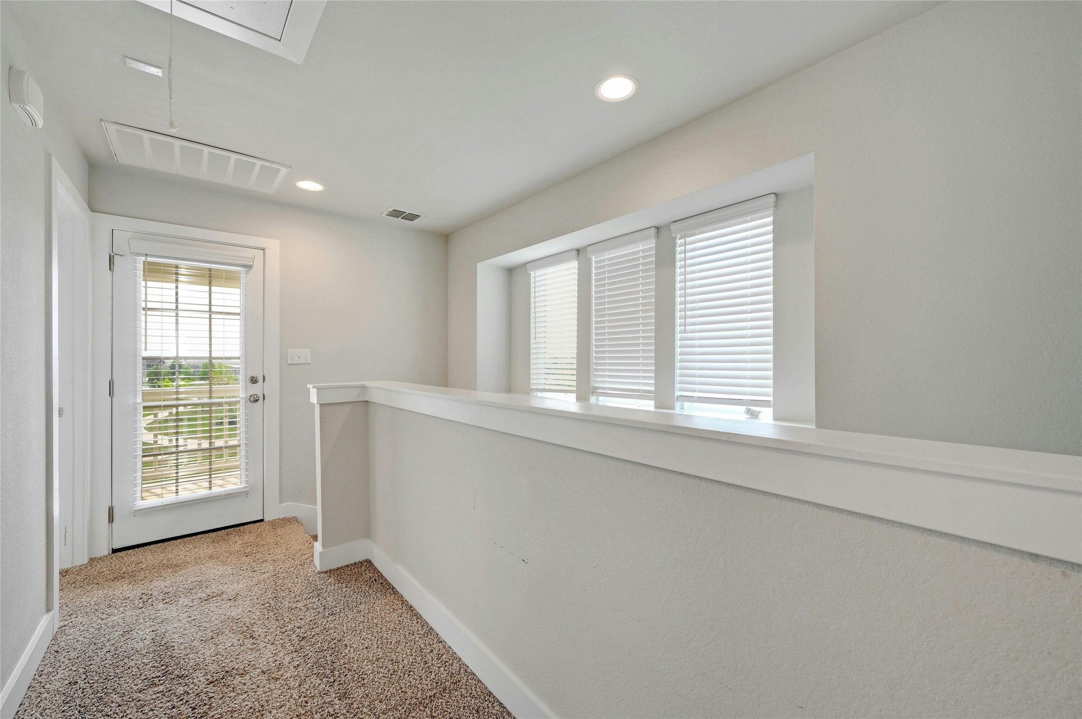121 Switchgrass Street San Marcos, TX 78666 - Photo 20 of 33 Upstairs hallway looking towards the door to the balcony.