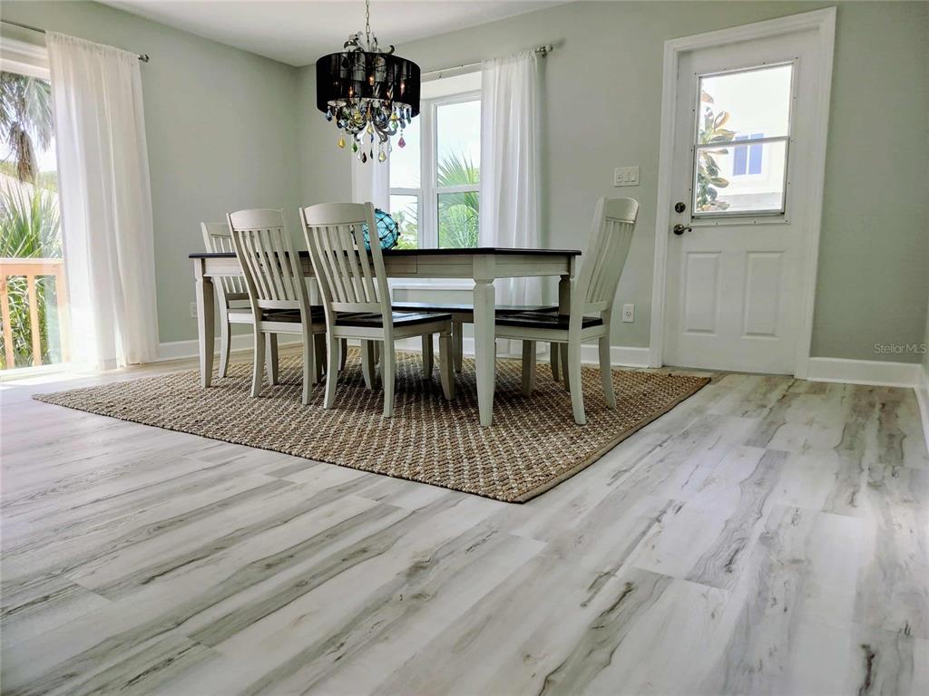 4766 South Atlantic Avenue Ponce Inlet, FL 32127 - Photo 12 of 32 a view of a dining room with furniture window and wooden floor