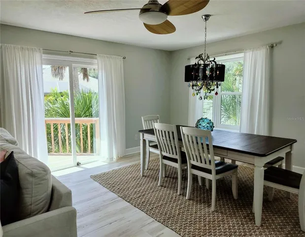 a view of a dining room with furniture wooden floor and chandelier