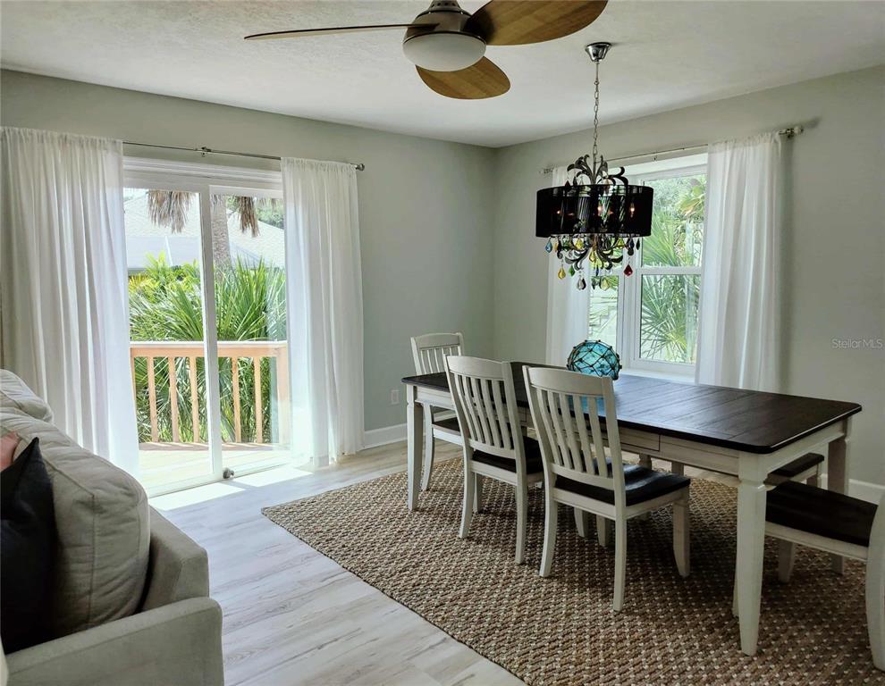4766 South Atlantic Avenue Ponce Inlet, FL 32127 - Photo 13 of 32 a view of a dining room with furniture wooden floor and chandelier