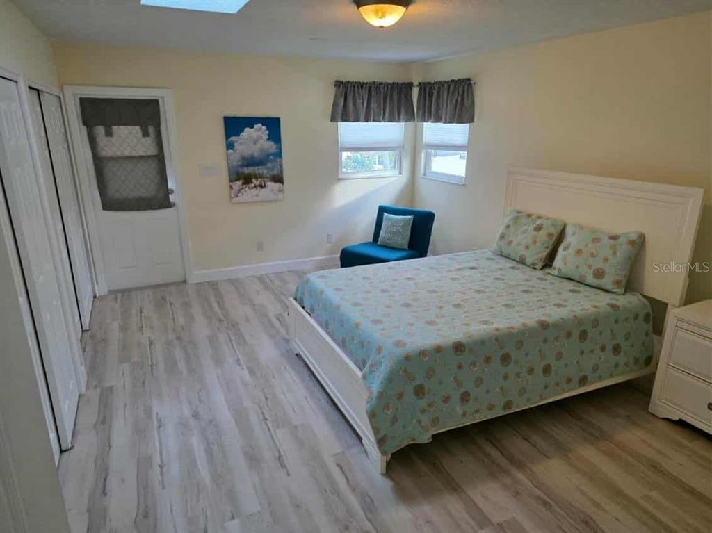 4766 South Atlantic Avenue Ponce Inlet, FL 32127 - Photo 18 of 32 a bedroom with a bed and window