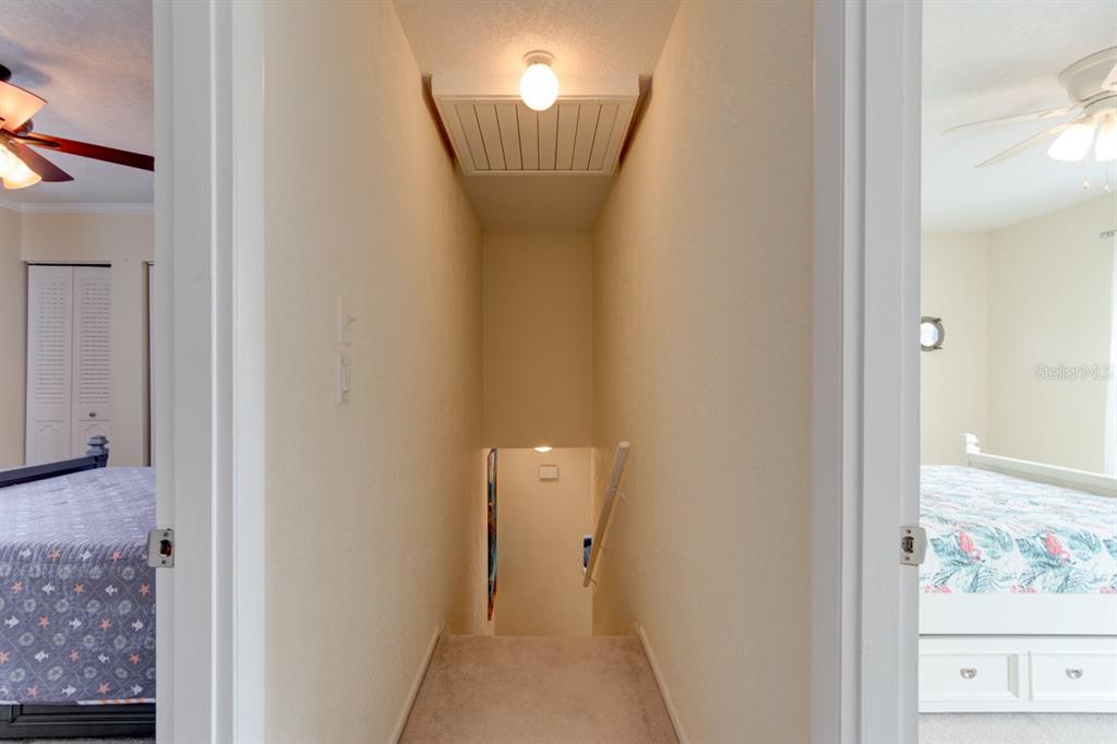 4766 South Atlantic Avenue Ponce Inlet, FL 32127 - Photo 19 of 32 a view of a hallway with paintings on the wall
