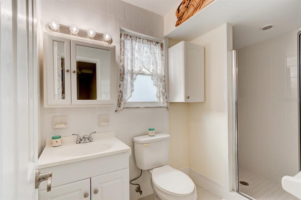 4766 South Atlantic Avenue Ponce Inlet, FL 32127 - Photo 20 of 32 a bathroom with a sink toilet and mirror