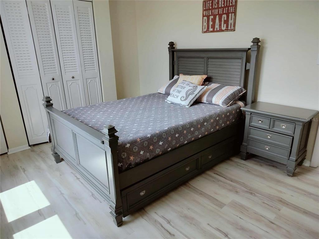 4766 South Atlantic Avenue Ponce Inlet, FL 32127 - Photo 24 of 32 a bed sitting in a bedroom next to a window