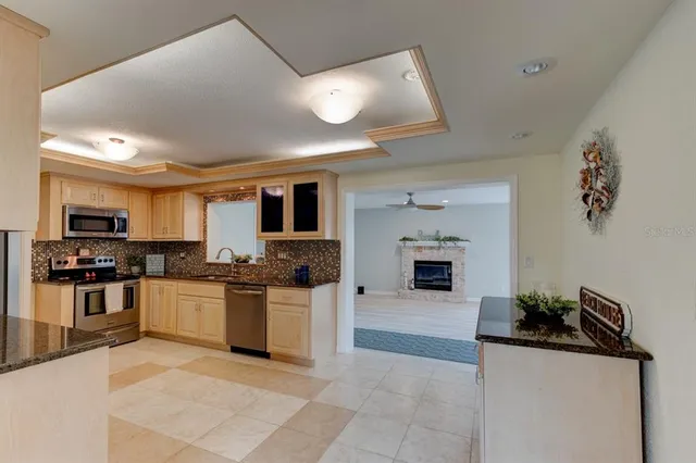 a kitchen with stainless steel appliances granite countertop a stove top oven a sink and dishwasher